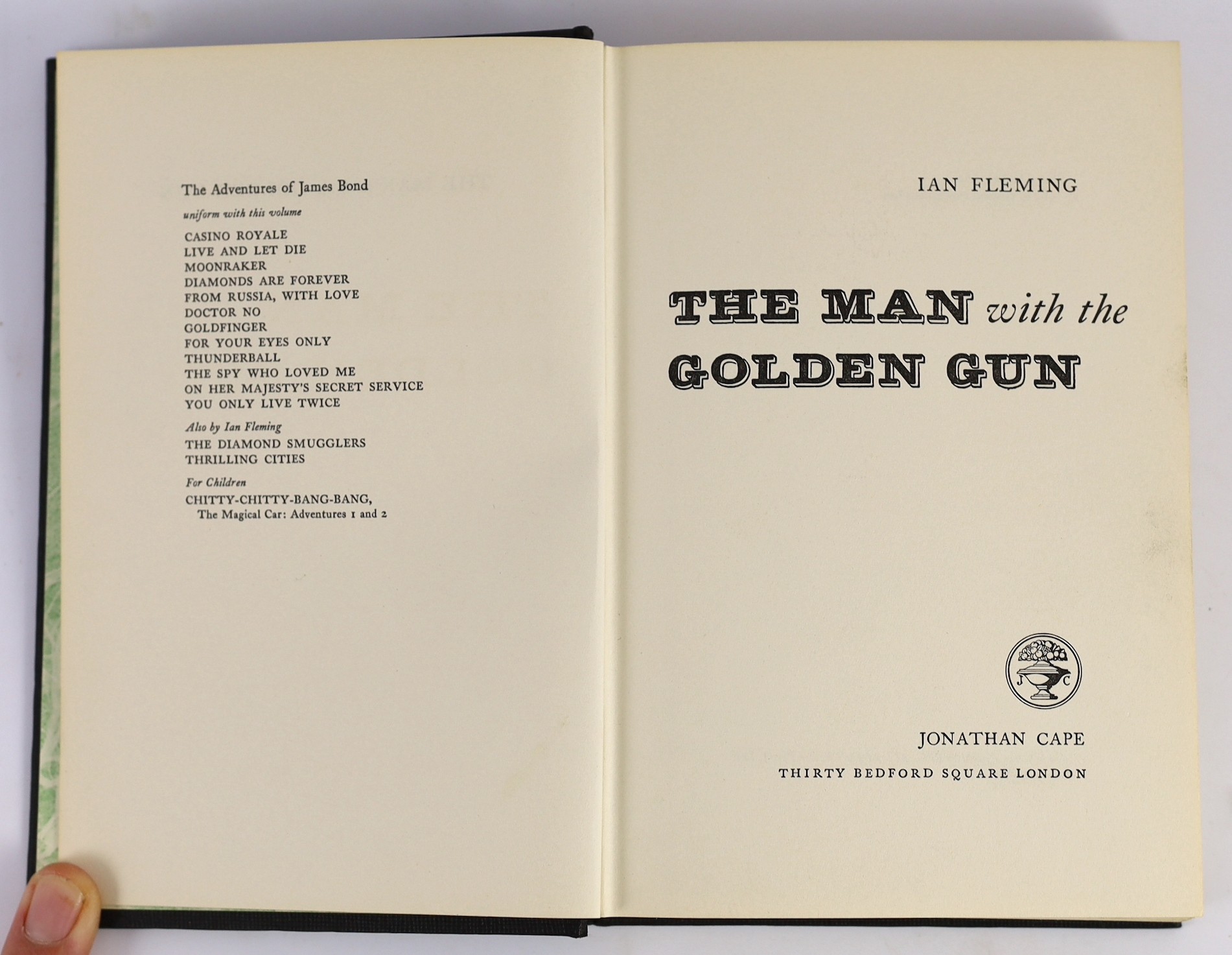 Fleming, Ian - The Man with the Golden Gun. First Edition. half title, publisher's black cloth, gilt-lettered on spine, in coloured pictorial d/wrapper, with the white and green patterned e/ps. Jonathan Cape, 1965